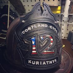 a helmet with the words cortland city written on it and an american flag