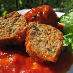 meatballs with sauce and spinach leaves on a plate