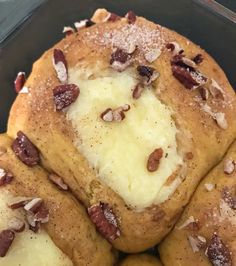 several pieces of bread with cheese and nuts on top