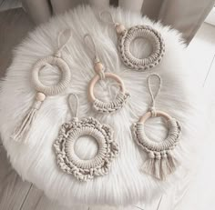 four pairs of earrings on a white rug