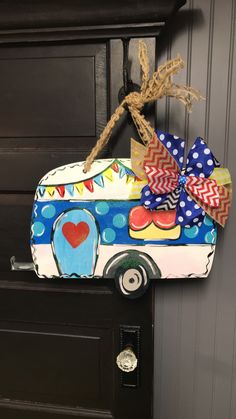 a decorated mailbox with a bow on the front and side of it, hanging from a door