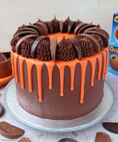 a chocolate cake with icing drizzled on top and cookies around it