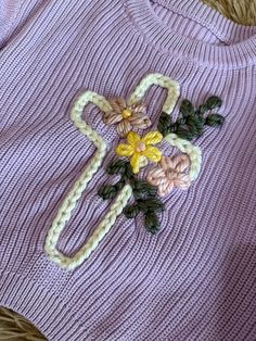 a knitted sweater with flowers on it