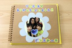 a spiral notebook with the words happy birthday written on it and three children in front