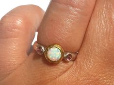 Opal Ring - Gold and Silver Ring - White Opal Pink Zircon Ring - Stackable Ring - Fire Opal Ring - 24k Gold - Opal Engagement Ring - Pink Zircon - Pink Ring. A lovely Opal (measures about 7 mm with the gold bezel around), with lots of pinks greens and more, is set in 24k solid gold, with small faceted pink Zircon (3 mm each) set in sterling silver on each side. The band is half round, hammered sterling silver (3 mm wide). Made to order in your size (Please pick your ring size in the drop-down me Pink Multi-stone Birthstone Ring, Pink Opal Gemstone Ring For Anniversary, Pink Opal Ring With Accent Stones As Gift, Pink Opal Round Ring For Anniversary, Pink Opal Rings With Gemstone, Pink Opal Rings For Anniversary, Pink Opal Gemstone Rings, Anniversary Pink Opal Round Ring, Gold Opal Engagement Ring