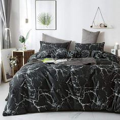 a marbled black and white comforter set with matching pillowcases in a bedroom