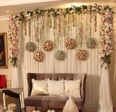 a living room decorated with flowers and greenery