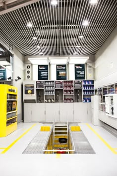 the inside of a store with yellow and white flooring