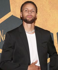 a man in a black suit and white shirt