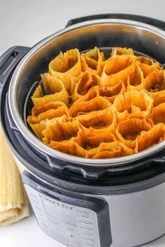 a crock pot filled with tortilla shells