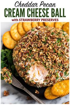 a cheese ball on a plate with crackers next to it and text overlay reads, cream cheese ball with strawberry preserves