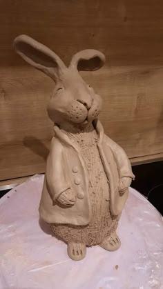 a clay rabbit sitting on top of a cake