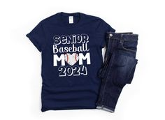 a t - shirt that says senior baseball mom with the number 22 on it next to jeans