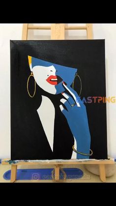 a painting on a easel with a woman holding a cell phone to her ear