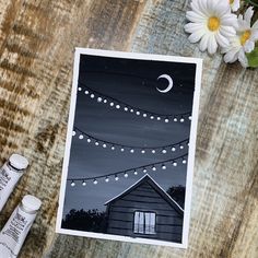 an image of a night scene with lights on the roof and flowers next to it