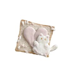 there is a piece of bread with a cat on it and two slices of bread in the shape of hearts