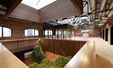 the interior of an office building with exposed ceilings and wood paneling on the walls