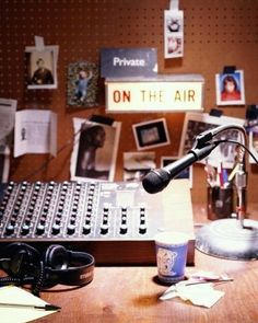 a recording studio with a microphone and sound board in the background, on the air