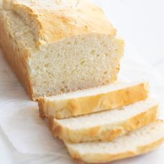 a loaf of white bread sitting on top of a piece of paper