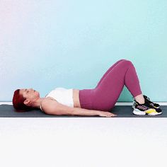 a woman laying on the floor with her legs crossed and wearing pink leggings