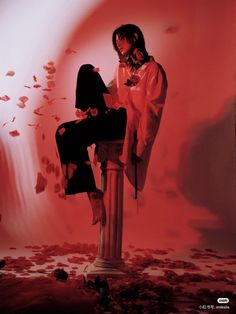 a woman sitting on top of a metal pole in front of a red background and falling petals