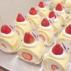 there are many small desserts with strawberries on them