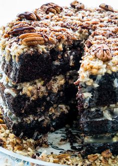 a large chocolate cake with pecans on top