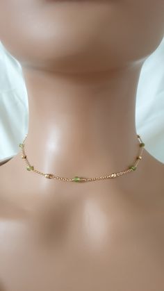 The necklace is made with gold plated chain, natural peridot beads (3 mm) and gold plated brass lobster clasp.  The length of the extension is approximately 2 inches.  Please contact me in case you have any questions. Please note: store your jewellery individually to keep them from scratching each other. Avoid contact with perfume, body lotions, hairspray or any other chemical. Dainty Gold Crystal Choker Necklace, Gold Crystal Necklaces With Delicate Chain And Round Beads, Gold Beaded Chain Crystal Choker, Dainty Green Beaded Chain Jewelry, Green Dainty Jewelry With Tiny Beads, Dainty Green Jewelry With Tiny Beads, Green Minimalist Beaded Chain Jewelry, Minimalist Green Beaded Chain Jewelry, Dainty Handmade Green Choker