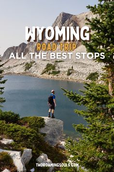 a man standing on top of a rock next to a lake with the words wyoming road trip all the best stops