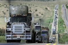 a large semi truck driving down a highway