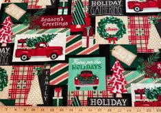 a christmas themed fabric with red and green plaid, trees, trucks, and holiday greetings on it