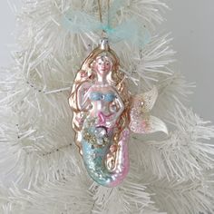 an ornament hanging from a white christmas tree