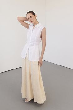 Sheer sleeveless shirt Lightweight Linen / Cotton blended fabrication Adjustable ties at waist for a cinched silhouette Collared neckline into a concealed button through closure Panel detailing through the bodice Please see studio image for most accurate colour Sleeveless Tops, Linen Dresses