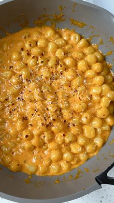 a pan filled with macaroni and cheese on top of a stove