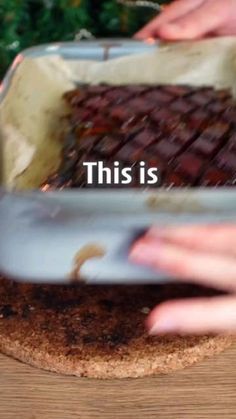 two hands reaching for food in a pan on a table with the words, this is