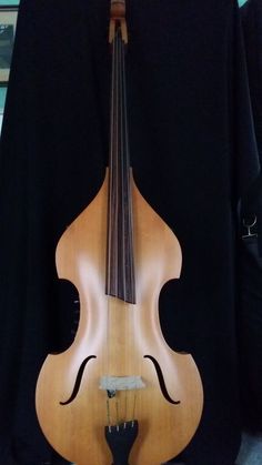 a wooden instrument sitting on top of a black cloth