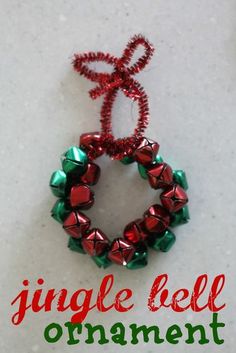 a christmas ornament hanging on a wall with the words, jingle bell ornament