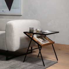 a white couch sitting next to a coffee table on top of a wooden floor