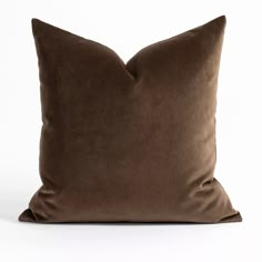 a brown pillow sitting on top of a white table