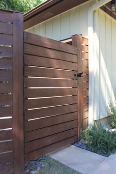 a wooden gate in front of a house