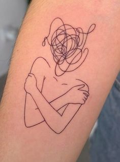 a woman's arm with a tattoo on it that has lines in the shape of a heart