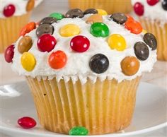 a cupcake with white frosting topped with gummy bears