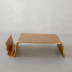 a small wooden table sitting on top of a white floor