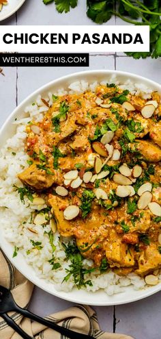 chicken paandaa served over rice with almonds and cilantro on the side