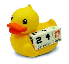 a yellow rubber duck holding a calendar block