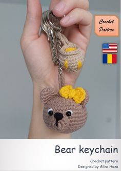 a crocheted bear keychain with a yellow bow on it's head