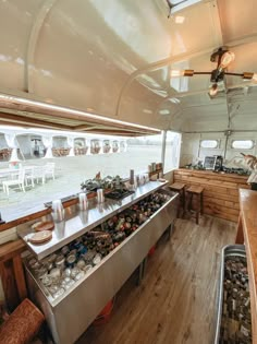 the inside of a camper with lots of food on the counter and in the back