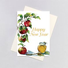 a happy new year card with apples and honey