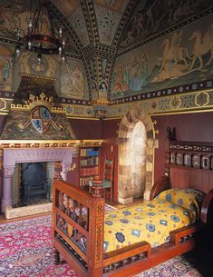 an ornately decorated room with a bed and fireplace