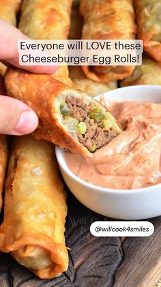 someone is dipping some food in a small white bowl with sauce on it and the words everyone will love these cheeseburger egg rolls